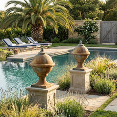 Pool area with decorative urns, lounge chairs, and palm trees