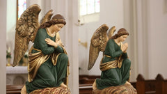 Statue of an angel in a reflective pose inside a church.