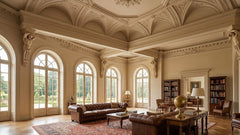 Luxurious living room with ornate ceiling, large windows, and elegant furniture.