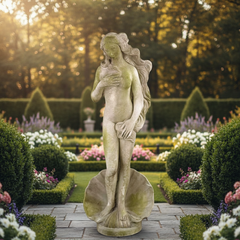 Statue of a woman in a garden with manicured hedges and flowers