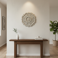 Boden Decorative wall art above a wooden console table in a room with plants.