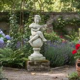Statue in a garden with flowers and plants