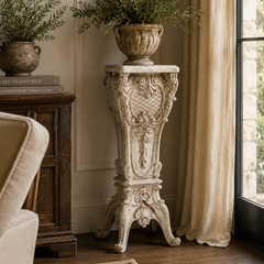 Decorative pedestal with potted plants in a living room setting