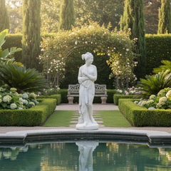 Statue in a garden with a pool and manicured hedges