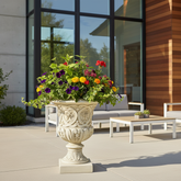 Decorative urn with colorful flowers on a patio with modern furniture
