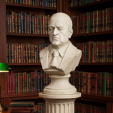 Bust of a man in a library setting with bookshelves in the background