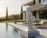 Statue by a pool with a modern house in the background