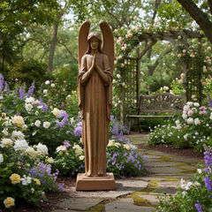 Statue of an angel in a garden with flowers and a bench