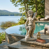Statue of a cherub by a pool with a scenic lake view Summer Season Cherub 24" H