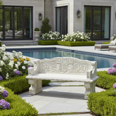 Decorative garden bench in a well-maintained garden with flowers and a pool in the background.