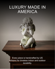 Statue of an angel on a wooden pedestal with text about American craftsmanship.