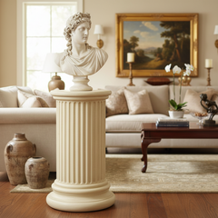 Decorative bust on a pedestal in a living room setting with a painting and furniture.