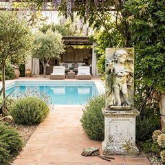 Garden scene with pool, statue, and stone pathway