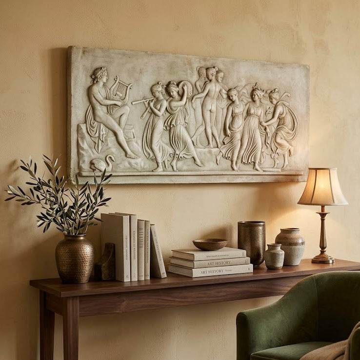 Decorative wall panel above a wooden console table with books and a lamp in a living room.