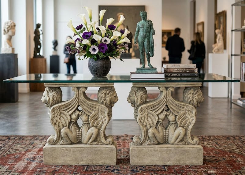Decorative table with lion statues in a room with sculptures and books