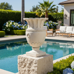 Apian Vessel 30 H - Architectural   Urns Decorative urn on a stone pedestal by a pool with garden and house in the background