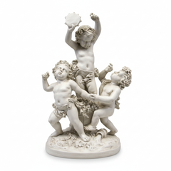 White marble sculpture of three cherubs on a white background