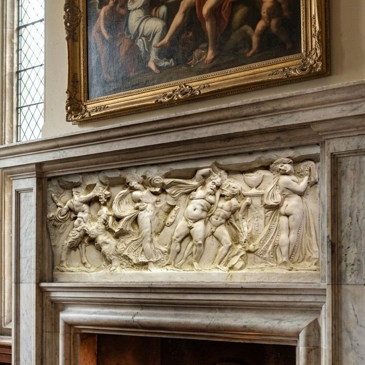 Bacchanale frieze right panel in aged cast stone, mounted across a carved stone fireplace mantel beneath an oil painting