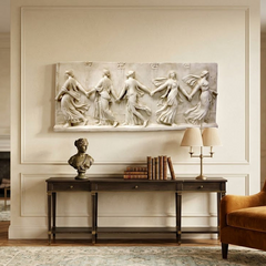 Living room with classical wall art, books, and a lamp on a console table.