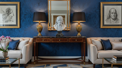 Benjamin Fraklin Decor Elegant living room with blue walls, gold accents, and classical art.