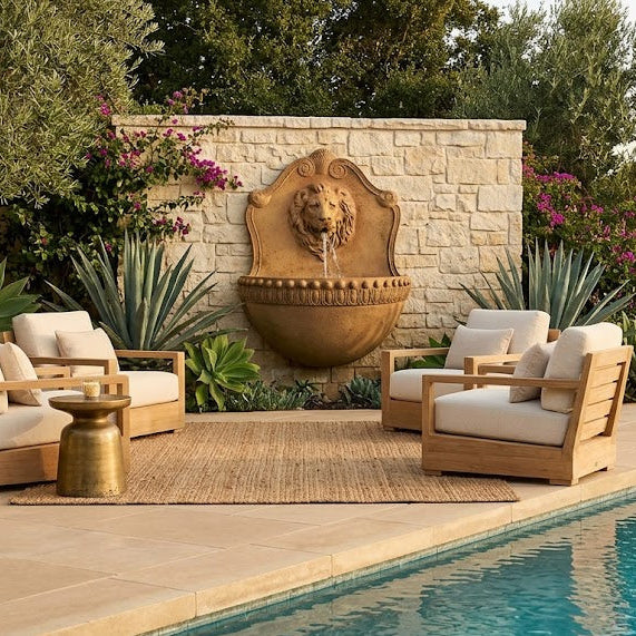 Outdoor patio area with furniture and a lion head fountain by a pool.