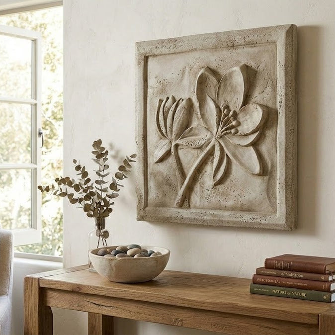 Decorative wall art with floral design above a wooden console table in a room with natural light.