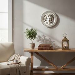 Living room with a wooden console table, plant, and decorative wall piece.