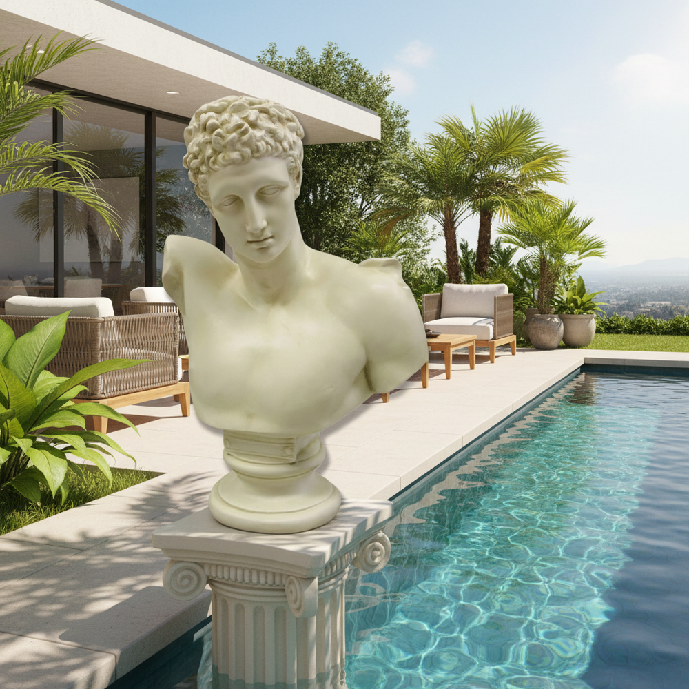 Statue of a classical bust by a poolside with a modern house and garden in the background
