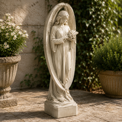 Statue of an angel holding flowers in a garden setting