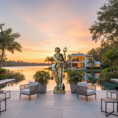 Luxury outdoor patio with statue, furniture, and sunset view