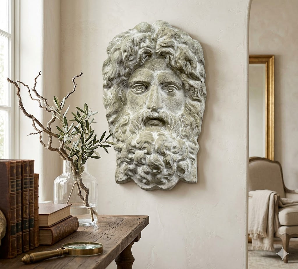 Decorative wall piece of a classical head with a beard in a room setting.