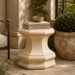 Decorative stone pedestal with books on a patio setting
