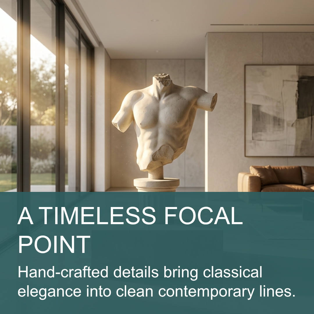 A classical-style stone torso sculpture displayed in a modern interior room with large windows, a sofa, and framed wall art. Large overlaid text reads: 'A TIMELESS FOCAL POINT' and 'Hand-crafted details bring classical elegance into clean contemporary lines.