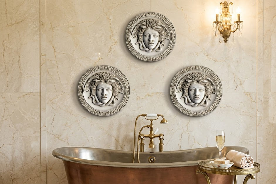 Decorative wall plates with face designs above a copper bathtub in a bathroom setting.
