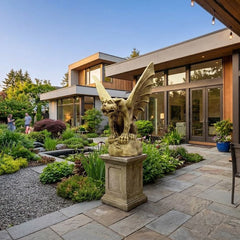 Modern house exterior with garden, statue, and outdoor furniture