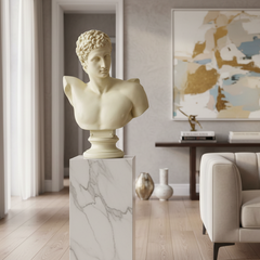 Modern living room with marble bust on a pedestal, sofa, and abstract art.