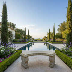 Garden scene with a stone bench, pool, and manicured hedges.